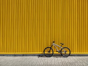 Bike leaning against yellow wall
